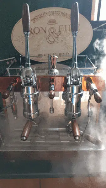 An image of a lever espresso machine steam.