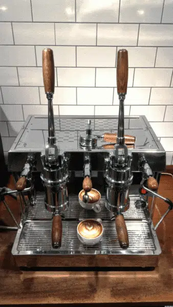 An image of a coffee lever machine making coffee.