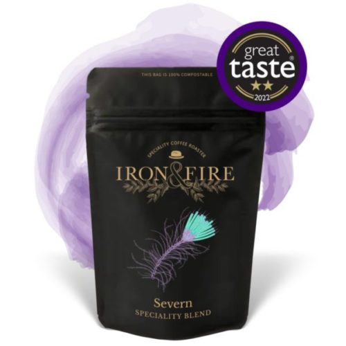 Black coffee bag with purple swish behind it and great taste awards logo