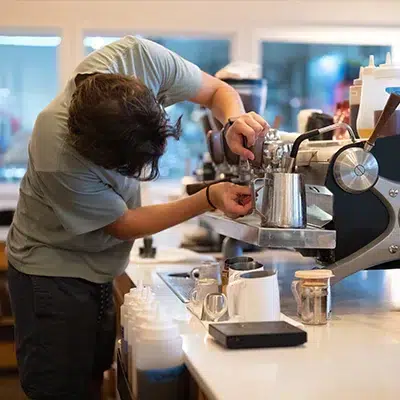 Image of a coffee machine being serviced.