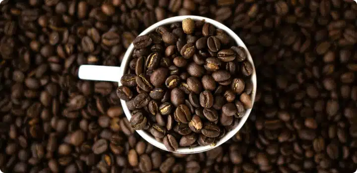 Coffee beans inside a mug.