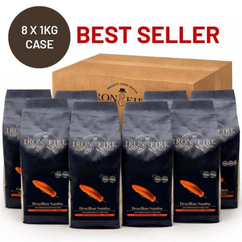 8 black bags of coffee standing with a cardboard box behind them